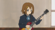 Yui with her new guitar at school.