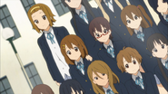 Ritsu's hand on Yui's shoulder during the class photo.