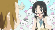 Mio quickly covering what she was doing to Ritsu