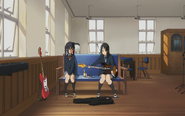 Azusa watches Mio set up her bass.