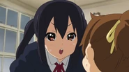 Azusa warning Ui not to tell Yui about the chocolate.