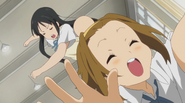 Ritsu getting whacked by Mio.