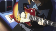 Yui playing guitar