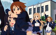 Ritsu cheering on Yui palpating Mio's fingertips.