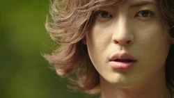 A close-up shot of Jogen's face, similar to the Amazon Riders.