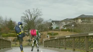 Gaim kicking his Ichigo Arms at Kamen Rider Fifteen.