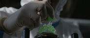 Nomi breaks apart a piece of stone that will be used to turn Aoi Izumi into the Mantis Kaijin.