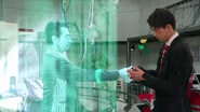 Shinnosuke giving his Shift Brace back to a hologram of Krim