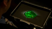 The green Magic Stone that would become the Hurricane Dragon and Thunder Wizard Rings in the possession of Masanori Kizaki.