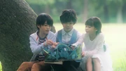 Touma, Luna, and Kento reading the Wonder Story book