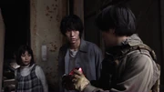 Irabu assists Junpei and Yukimi.