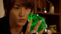 Haruto holding a green magic stone