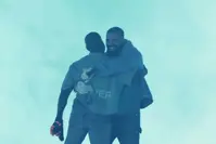Ye and Drake hugging in the concert.
