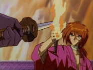 Kenshin blocking Shishio's Homura Dama attack