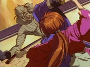 Kenshin hitting Shishio in the abdomen with his sneath