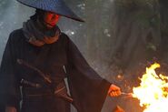 Live action Jin-e creating a bonfire while waiting for Kenshin