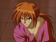 Kenshin standing up with his wounded shoulder