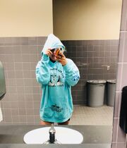 Kesha wearing a sweatshirt from the Adventures tour