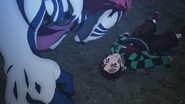 Akaza attacks an injured Tanjiro.