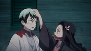 Yushiro being patted on the head by Nezuko.