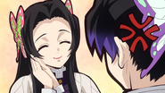 Kanae telling Shinobu not to be so angry and smile, annoying her.