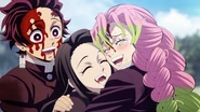 Nezuko being hugged by a relieved Mitsuri.