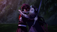 Tanjiro tries to tell Nezuko she is in danger.