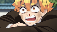 Zenitsu looks up at Tanjiro.