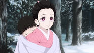Nezuko carries a sleeping Rokuta.