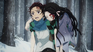 Tanjiro carrying a wounded Nezuko