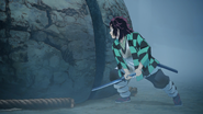 Tanjiro slicing the boulder.