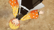 Zenitsu unconscious after falling out of the Drum House.