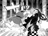 The Temple Demon's body attacks Nezuko.