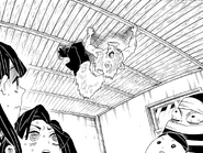 Inosuke appears on the ceiling above Tanjiro