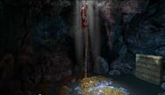 Graham hangs from a rope with light streaming in from above (entrance to from Forest Well). Below him is a pile of treasure in a shallow pool of water (a strange mattress lies to one side). There is no swimming in this story's universe, and its strongly implied Graham does not know how to swim.