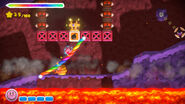 Kirby about to obtain a chest in a volcanic environment.