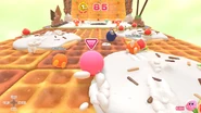 Kirby races opponents on a wide road of waffles.