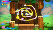 Kirby rides a spiraling rainbow rope.