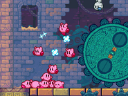 The Kirbys roll Great Gear through the ruins. (Stage 6)