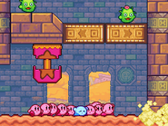 The ruins around the Kirbys sink into the sand. (Stage 10)