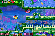 Kirby is pursued by a Blipper while swimming through the level.