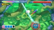 Hooplagoon blasts Kirby with a laser beam.