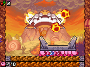 The boss, Skullord, shoots lava bombs at the Kirbys.