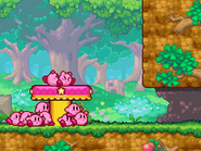 The Kirbys work to push down a switch.