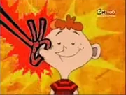 A boy smiling with a Cheek Tazer in his mouth.