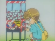 Akito buys gashapon toys with the bet money he got from the kiss