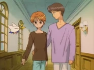 Takamitsu Kawai wraps his arm around Asako, not knowing she's dating Rei