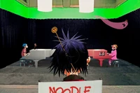 The band with Elton John during the filming of The Pink Phantom music video in the green screen room