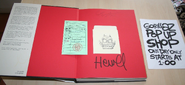 A signed 1st edition copy of RotO w/library card and signing event flyer