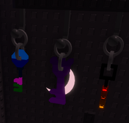 All three keys hanging on the wall next to the graveyard door.